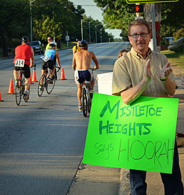 Martin Herring cheers cyclists in the Mayor's Triathon, Mistletoe Heights cheer station, July 7, 2013
Photo by Jim Peipert
