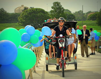 Robin Glaysher, owner of Fairmount Bike Taxi, carries dignitaries across the new Phillys J. Tilley Memorial Bridge in one of her pedicabs, Aug. 25, 2012
Photo by Jim Peipert
